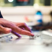 Close-up photo of a hand adjusting dials on a music mixer