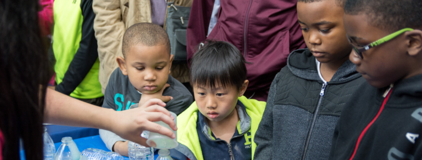 Group of children watching a scientific experiment