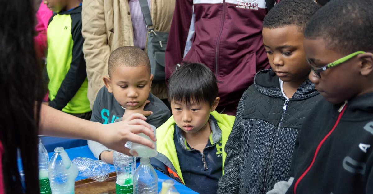 Group of children watching a scientific experiment
