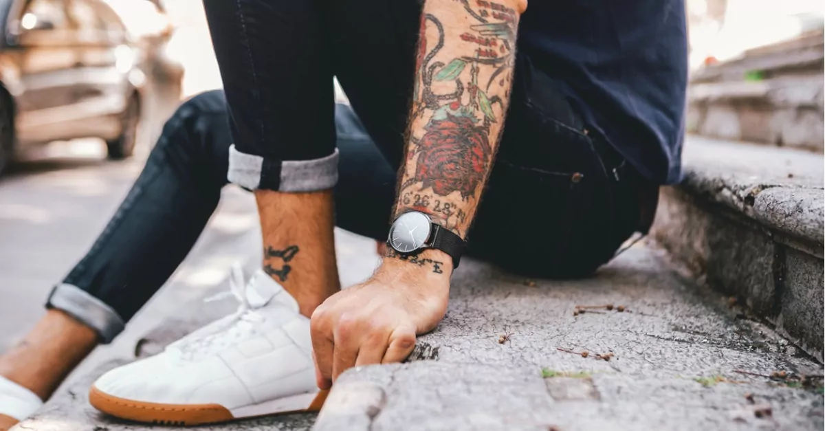 Young man with colorful tattoo sleeve.