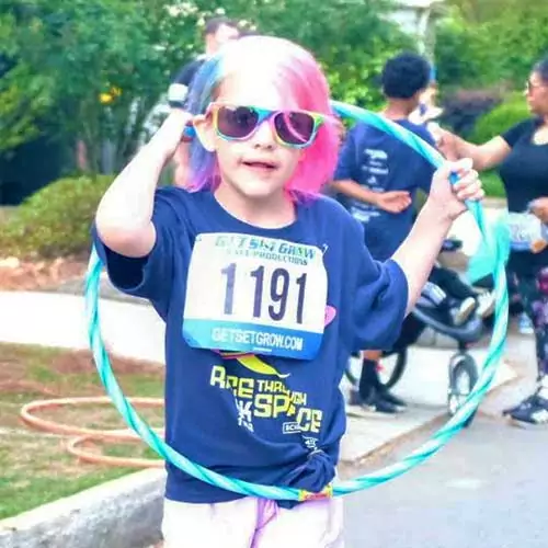 Young girl holding hula hoop at Race Through Space.