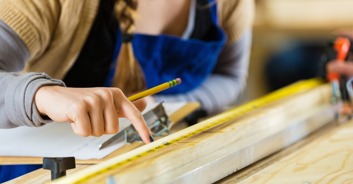 Close-up shot of a young woman in a makerspace working on a project.