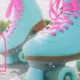 Close-up shot of a woman wearing colorful teal rollerskates with hot pink laces