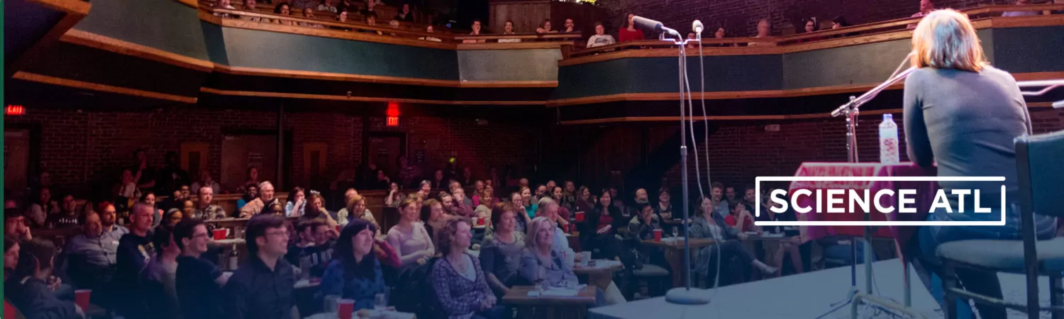An audience in a theatre watching a performer.