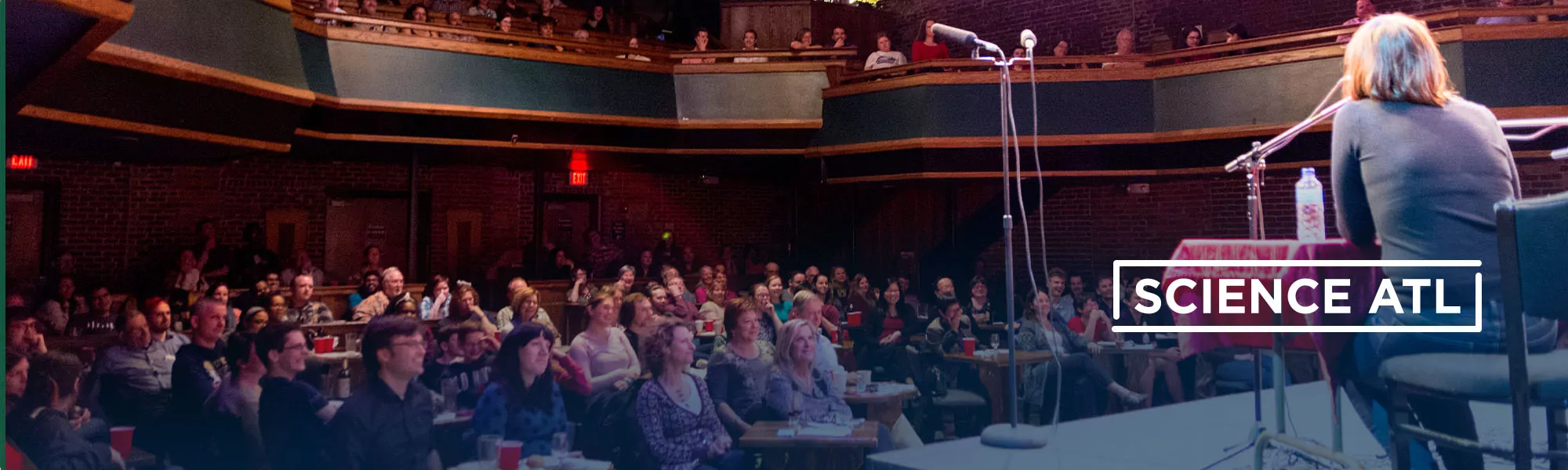 An audience in a theatre watching a performer.