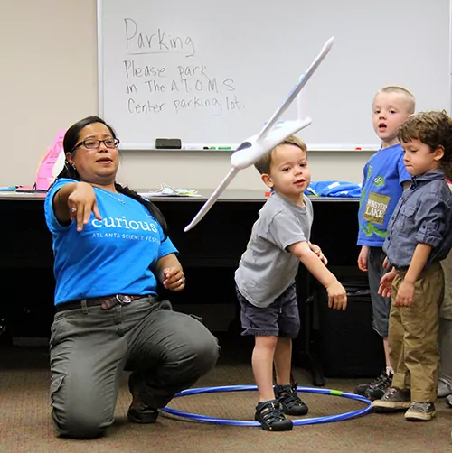 Kids playing with a toy airplane.