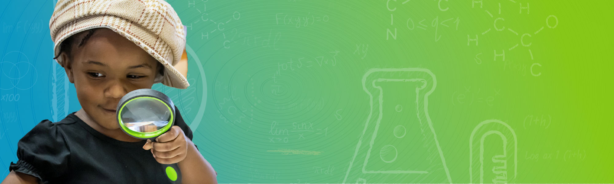 A science-curious child looking through a magnifying glass.