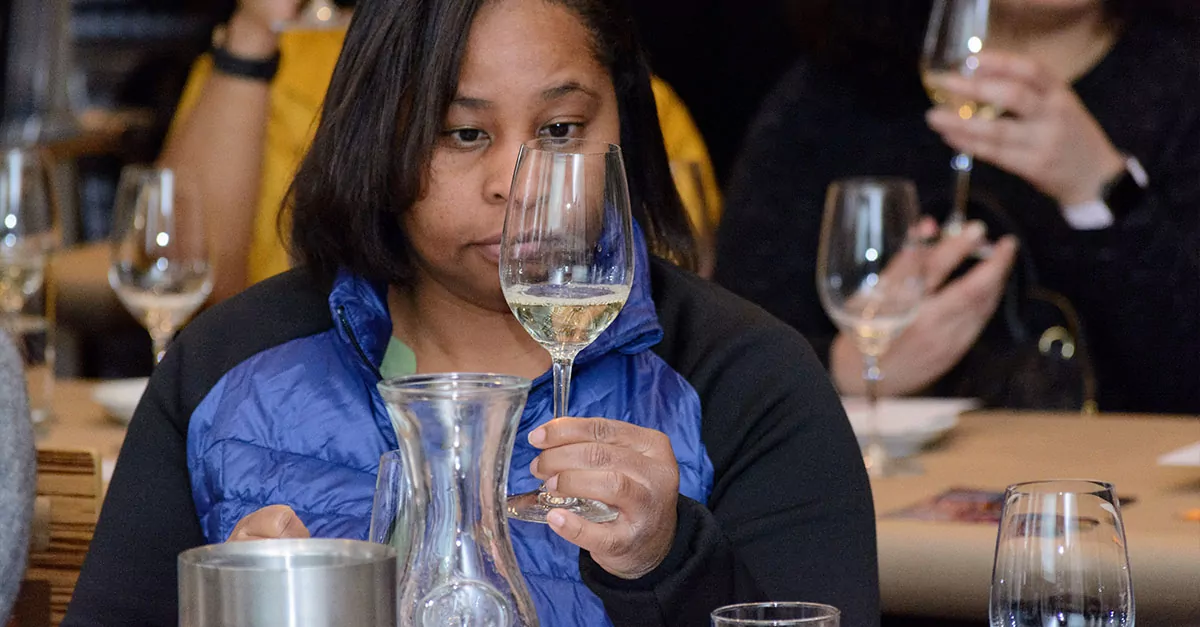 A foodie looking into a glass of wine.