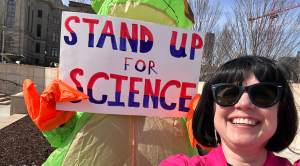 Jennifer Leavey_award woman with sign that says "stand up for science"