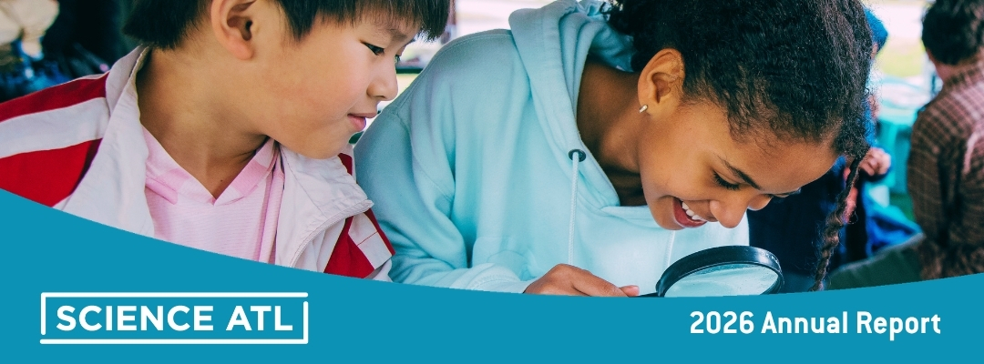 SciATL DAF Page (1080 x 400 px) A boy and girl in close-up investigating something on an unseen table with a magnifying glass.